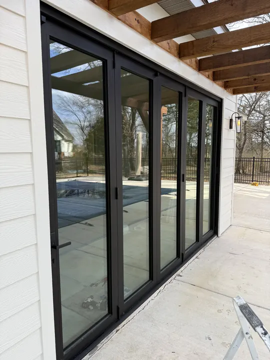 Black-frame folding glass doors along a covered patio