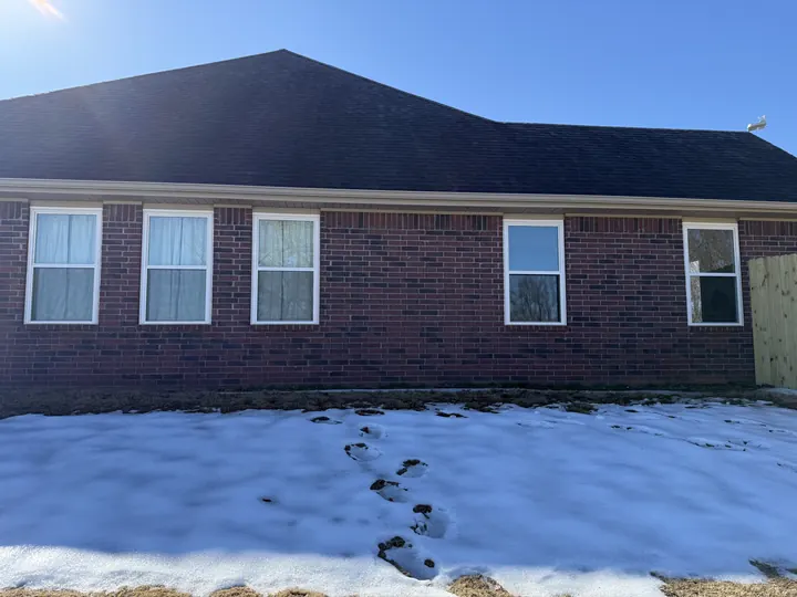 Brick ranch home with a row of white windows