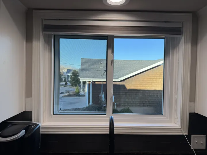 Interior view of a new sliding window above a kitchen counter