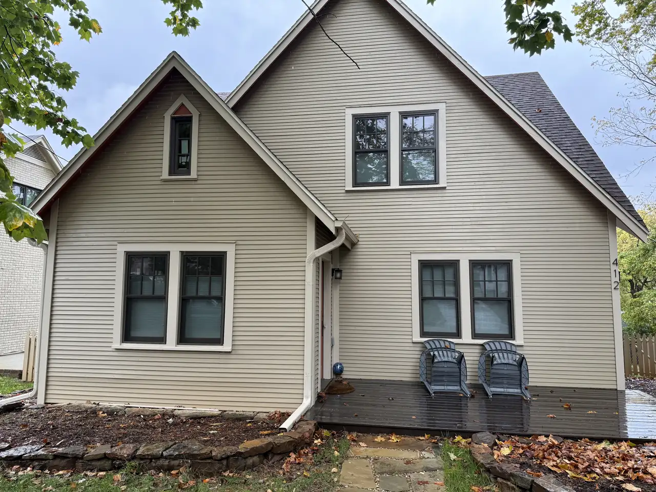 Tan-sided home with new black-frame paired windows